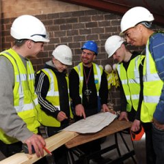 Young people and tradesman discuss a DIY project